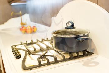 Stove with saucepan on the modern kitchen