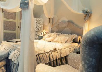 Nice luxury big white bed with pillows in a bedroom