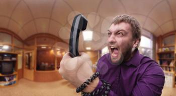 Angry businessman man screaming into the phone