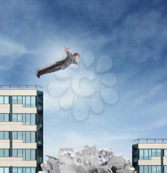 Businessman is jumping to the heap of documents