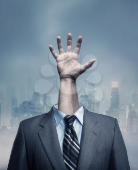 Businessman with hand instead of head over city background