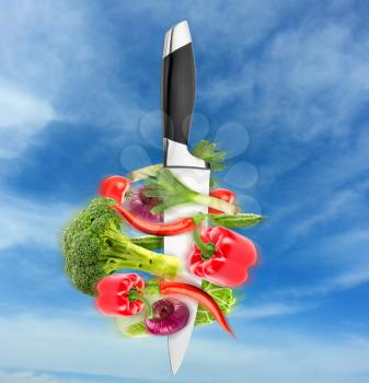 Big chief knife with vegetables round it - healthy eating