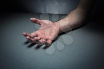 Human hand on the grey table