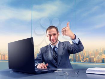 Happy successful businessman smiling in the office
