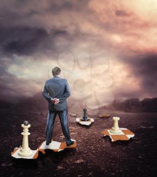 Businessman standing on the broken chess board 