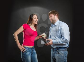 Woman taking money from husband's wallet