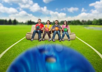 Bowling team sitting on the sofa on the lawn