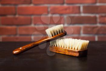 Two barber's brushes on the wooden table