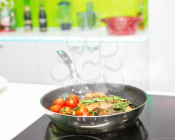 Cooked meat with vegetables in the frying pan