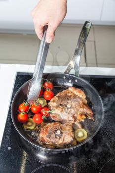 Meat with vegetables on the frying pan