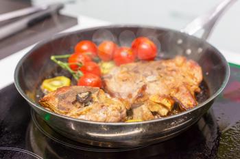 Meat with vegetables on the frying pan