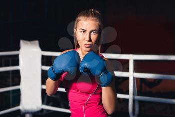 Portrait of young woman boxing