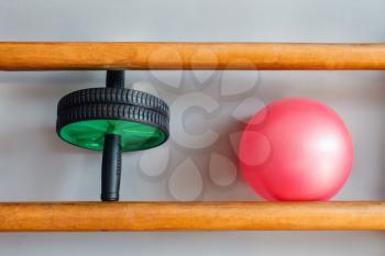 Crossfit equipment: ab roller and ball on the shelf