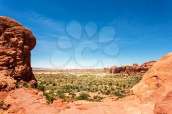 Arches National Park landscape with red rocks and skyline background. Sandstone natural beauty.