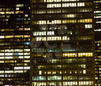 Night cityscape of skyscraper. Closeup of office building.
