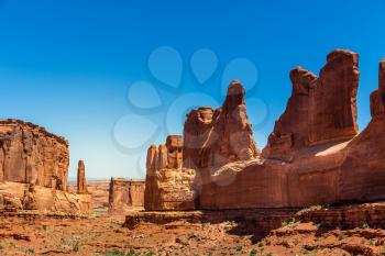 Mountains in valley against blue sky background. Landscape of Arches National Park