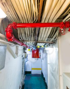 Electrical wires and fire pipeline on aircraft carrier. Military ship cable bunch. 