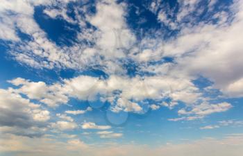 Cloudscape on deep blue sky. Background and wallpaper pattern