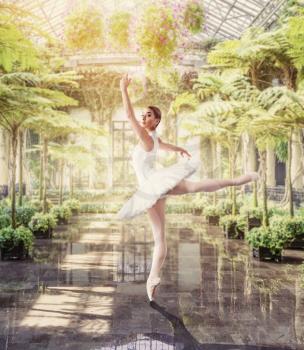 Female ballet dancer posing, green botanical garden on background
