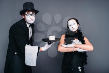 Mime actors comedy performing with a glass of water. Pantomime theater performers