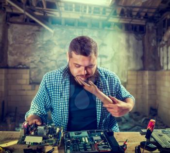 Male engineer cant fix problem with computer hardware. Electronic devices repairing technology
