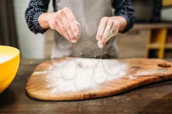 Female person hands in the flour, cake cooking. Dough preparation