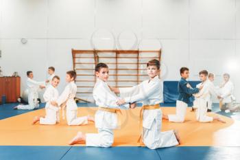 Kid judo, children on fight training, martial art, self-defense. Little boys in uniform in sport hall, young fighters