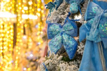 Christmas tree with blue decor and lights, garland closeup. Xmas decoration, new year. Winter holiday celebration
