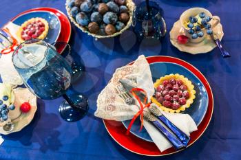 Festive table decorated with fruits and berries, top view, nobody. Holiday celebration