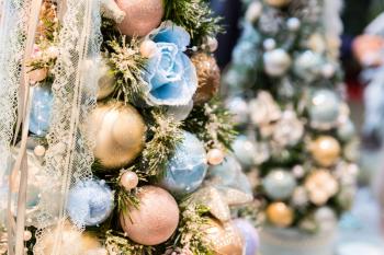 Christmas tree decorated with blue and gold balls closeup. Xmas decor, new year. Winter holiday celebration