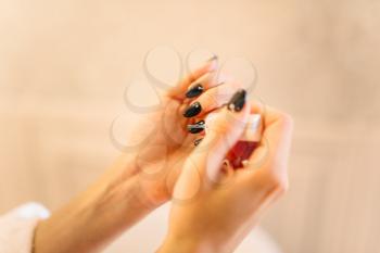 Female person hands with nail polish closeup. Manicure procedure, nailcare treatment process