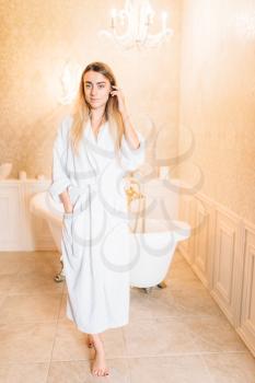 Beautiful woman in white bathtube, bathroom on background. Bodycare and hygiene, healthcare 
