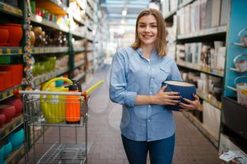 Female customer with pot, shop for gardening. Woman buying equipment in store for floriculture, florist instrument purchasing