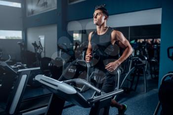 Male athlete workout on running exercise machine. Active sport training in gym