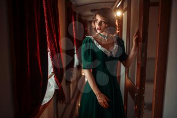 Railway journey, woman in retro train, rich interior. Old wagon. Railroad voyage