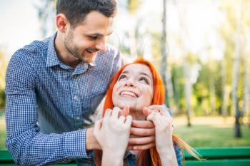 Romantic meeting of love couple in summer park. Man and woman hugs outdoors