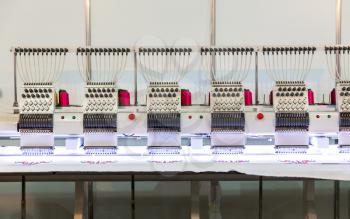 Professional sewing machine in work on textile fabric, nobody. Factory production, sew manufacturing, needlework technology