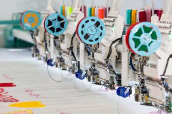 Factory sewing machine makes color pattern closeup. Textile fabric, nobody. Sew manufacturing, needlework technology