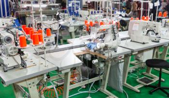 Sewing factory, nobody, overlock, stitching machines. Clothing sew Textile fabric and cloth manufacturing