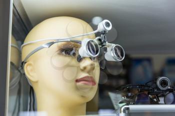 Medical training mannequin head, magnifying glass, professional medicine equipment. Healthcare technology
