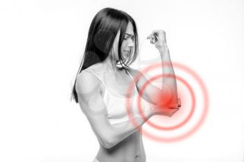 Joint pain, woman have problem with elbow, white background. Female person in white lingerie, medical advertising or concept