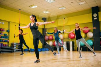 Women group on fitness workout, aerobic. Female sport teamwork in gym. Girs on fit training