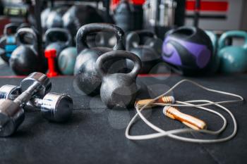 Kettlebells and dumbbells closeup, sport equipment in gym, fitness club interior, bodybuilding concept