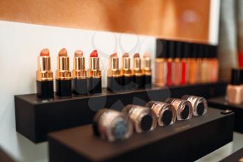 Lipstick collection, showcase in beauty shop closeup, nobody. Makeup products in store, cosmetic department