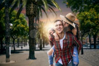 Couple of tourists on vacation under palms. Summer adventure of young man and woman