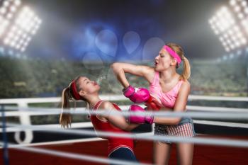 Two female kickboxers fights on the ring. Fighting sport and martial art concept