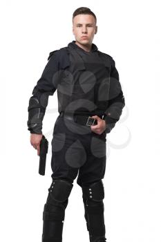 Armed special force soldier in black uniform and body armor, white background. Police officer, law guard