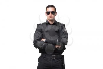 Seriuse cop in sunglasses and black uniform with body armor on white background. Policeman in special ammunition