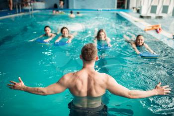 Male trainer works with female group on workout in swimming pool. Aqua aerobics training, water sport 