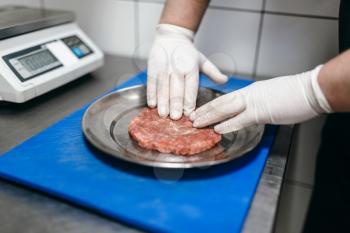 Chef hands in gloves prepares meat, burger cooking. Hamburger preparation process, fast food, bbq